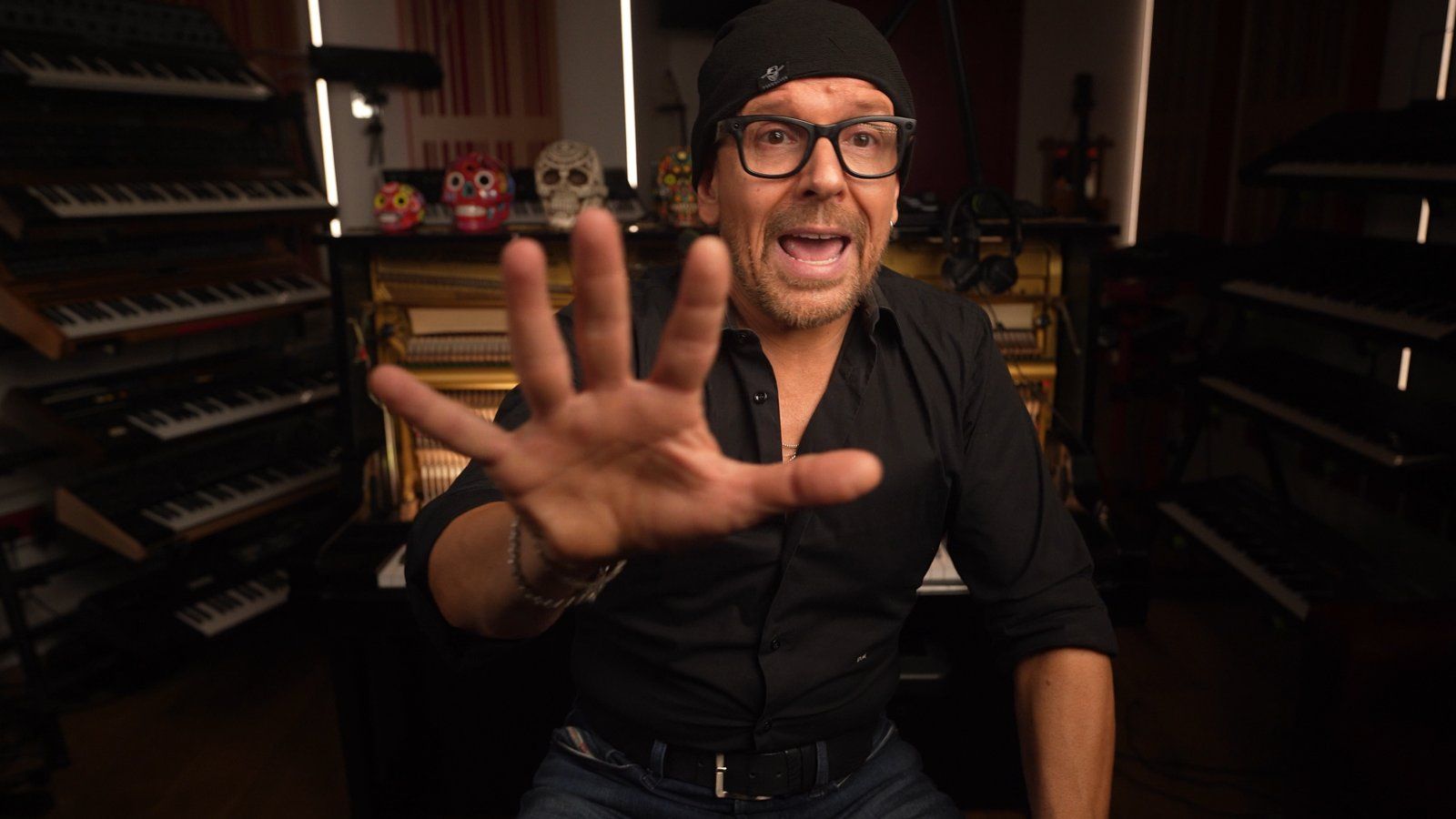 Claudio holding up a hand mid-sentence