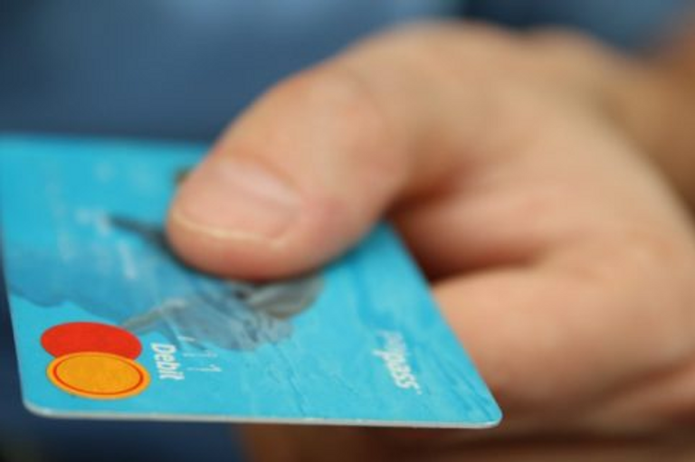 Hand reaching out with credit card