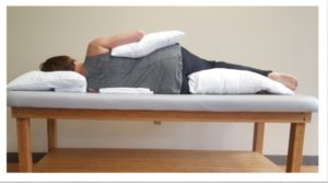 Woman laying on her side on a physical therapy table