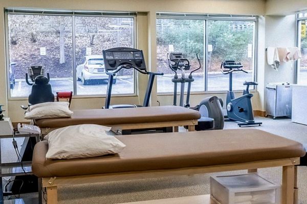 Inside view of Restorations clinic with treadmill, bike, and other equipment