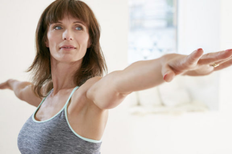 Woman with arms outstretched doing yoga