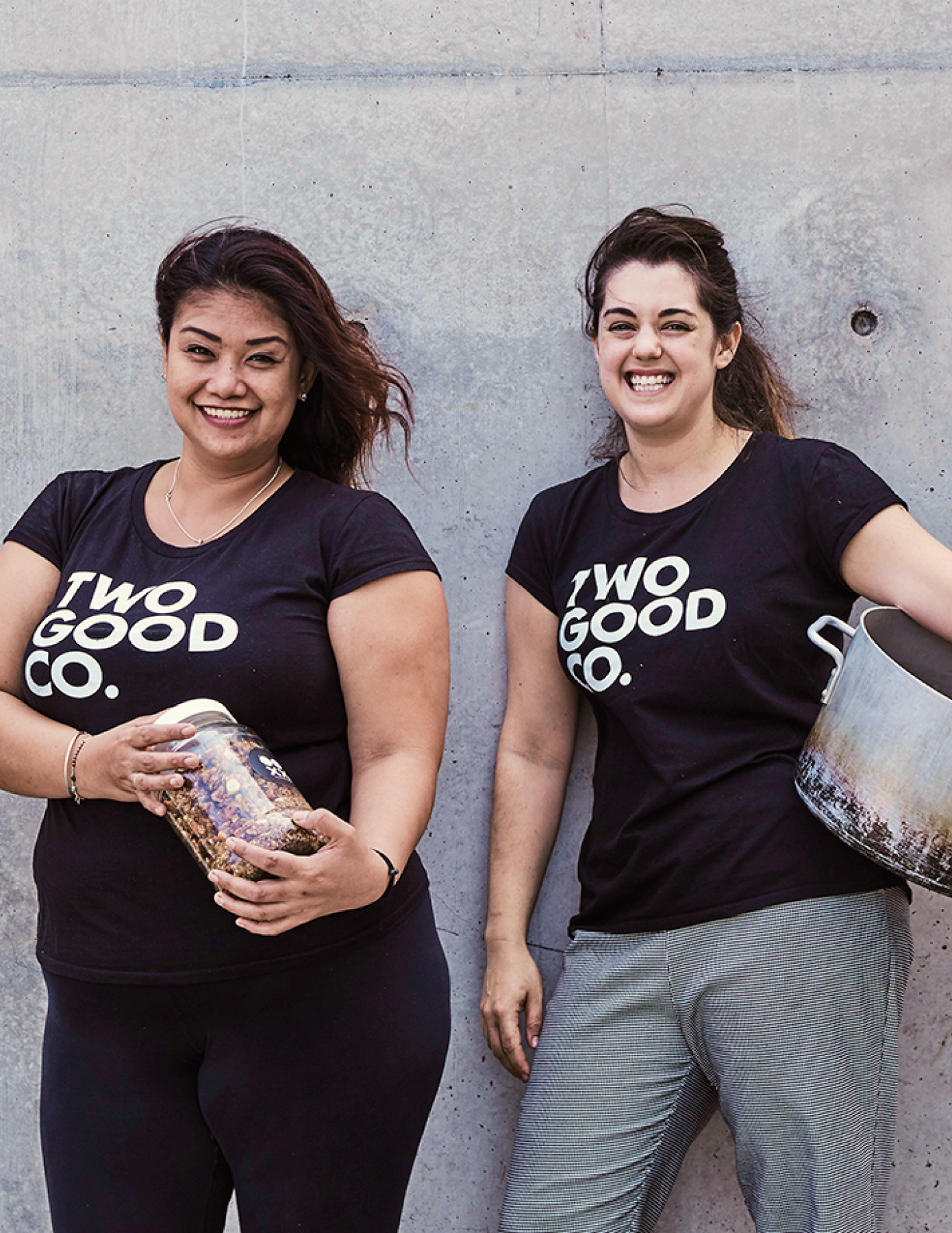 Two Women wearing Two Good Co. shirts smiling