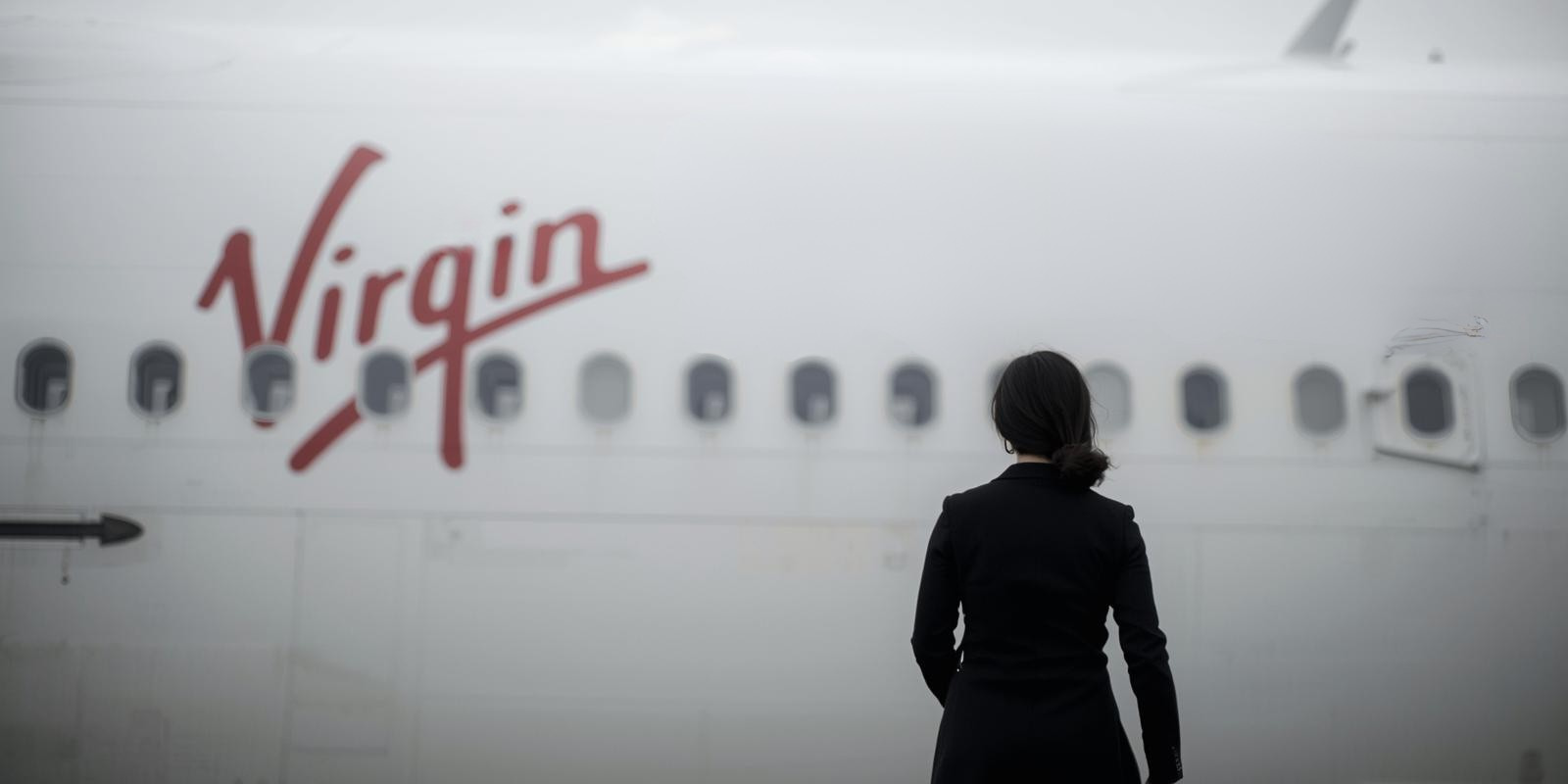 A lady standing in front of a plane