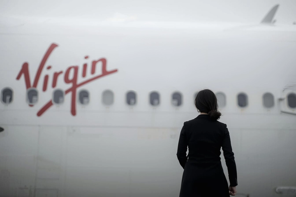 A lady standing in front of a plane