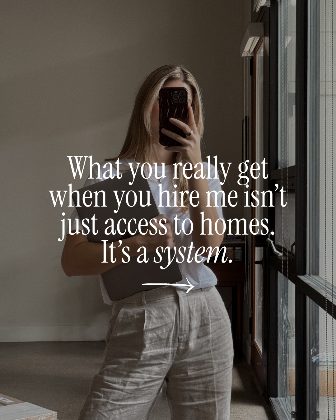 A real estate social media template featuring a woman taking a mirror selfie in a neutral-toned room with overlay text reading, “What you really get when you hire me isn’t just access to homes. It’s a system.”
