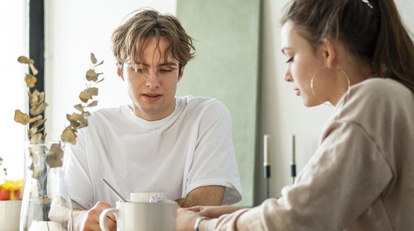 A young man and woman talking to eachother