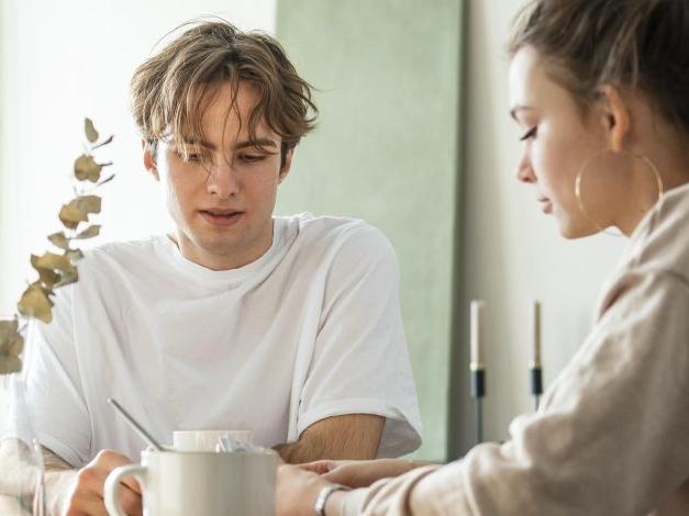 A young man and woman talking to eachother