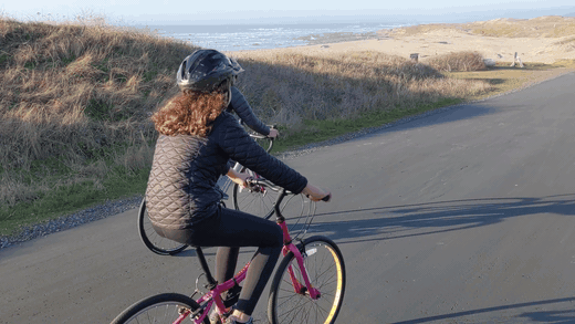 The Steele family riding bikes on the paved coastal bike path at MacKerricher State Park with dunes and the beach alongside The Steele family riding bikes on the paved coastal bike path at MacKerricher State Park with dunes and the beach alongside