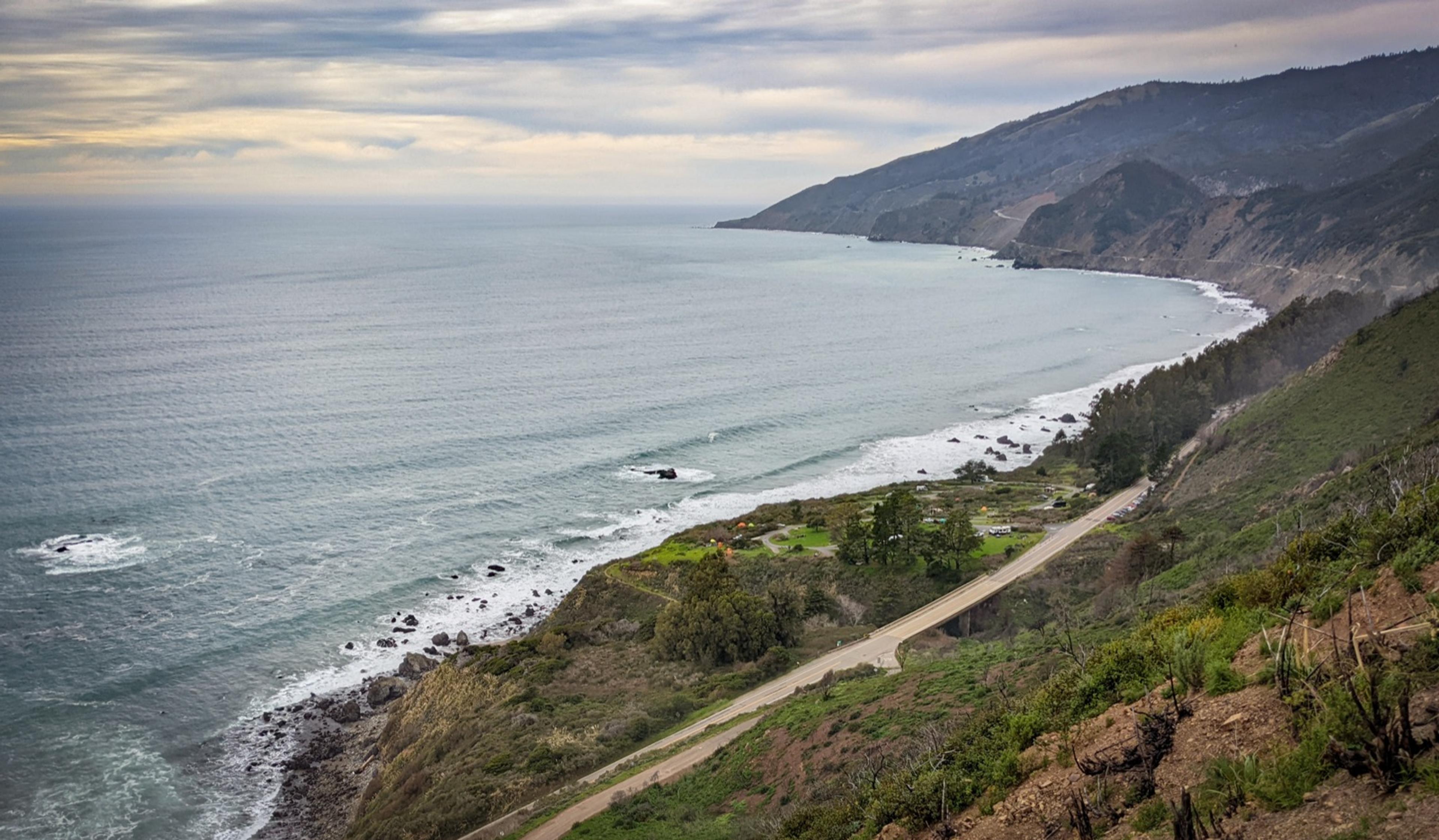 Aerial view of Kirk Creek Campground on a coastal bluff above the Pacific with Highway 1 curving past it Aerial view of Kirk Creek Campground on a coastal bluff above the Pacific with Highway 1 curving past it