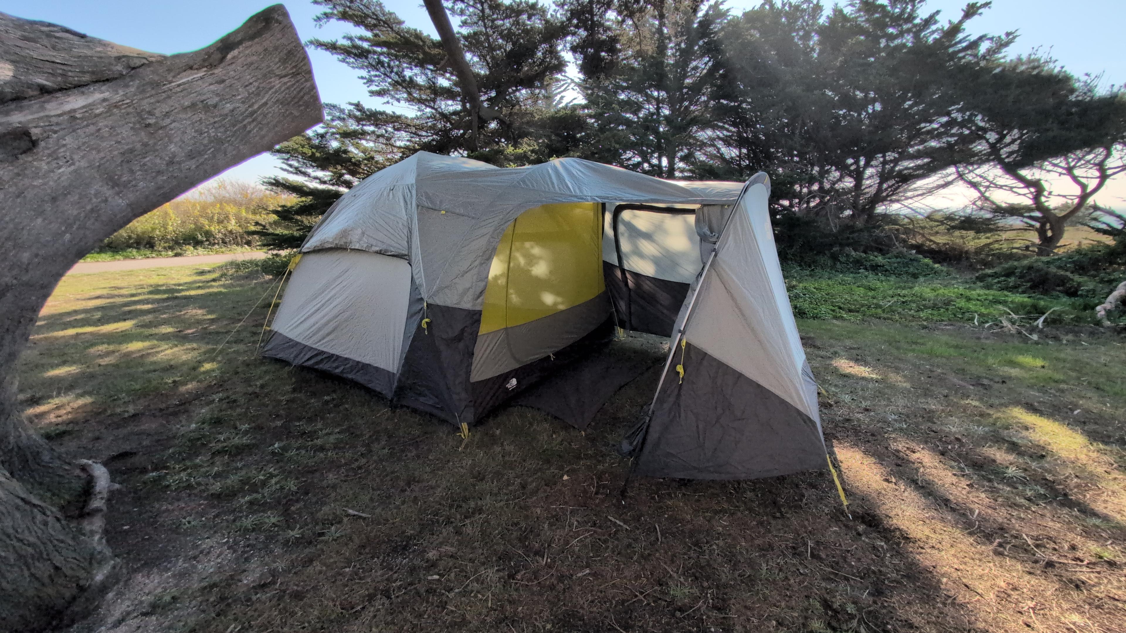 Fully assembled North Face Wawona 6 tent with vestibule extended at a campsite
