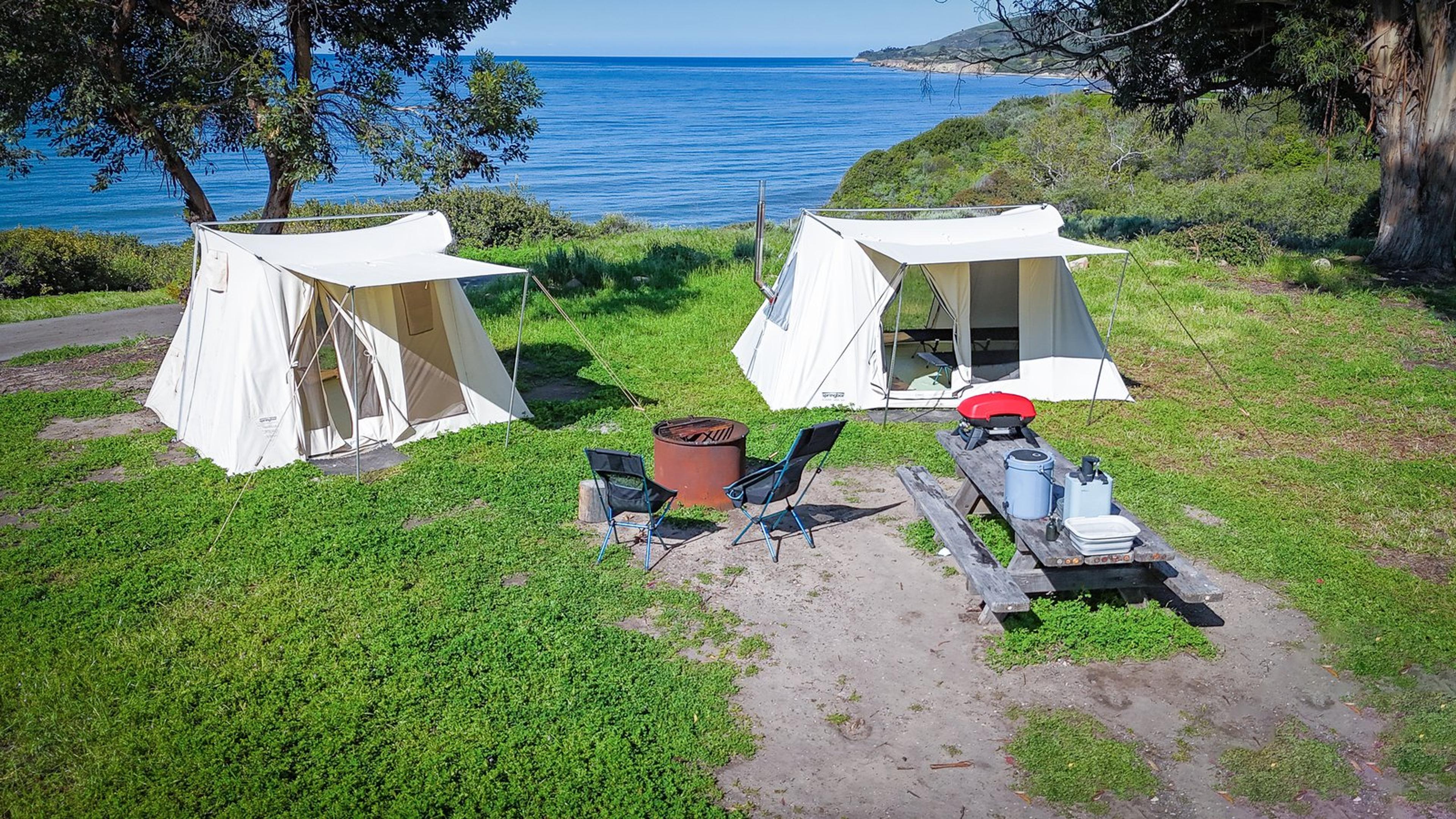 Two Springbar canvas tents set up at a scenic coastal California campground Two Springbar canvas tents set up at a scenic coastal California campground