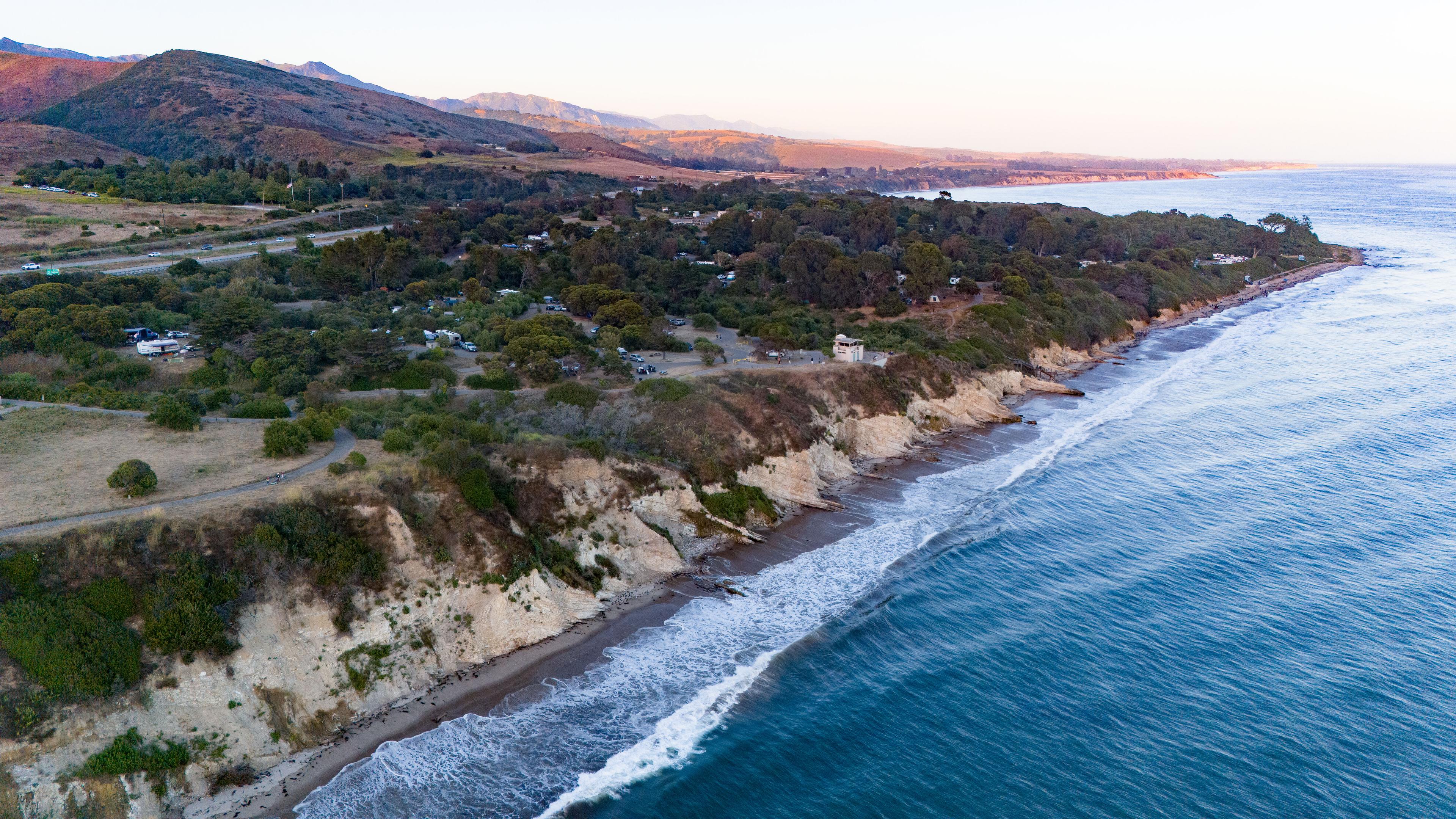 Aerial of El Capitan State Beach: wooded blufftop campground above a narrow surf beach on the Santa Barbara coast Aerial of El Capitan State Beach: wooded blufftop campground above a narrow surf beach on the Santa Barbara coast