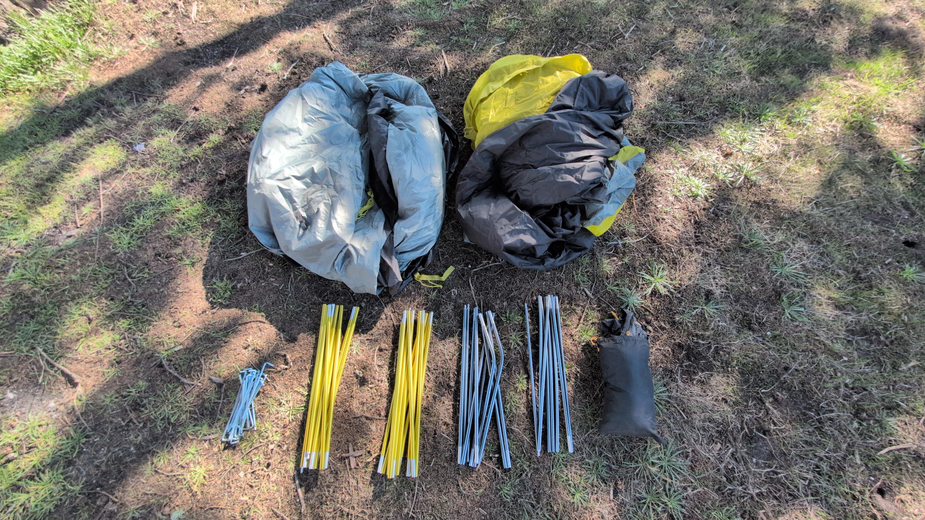 All North Face Wawona 6 tent parts laid out and labeled on the ground before setup