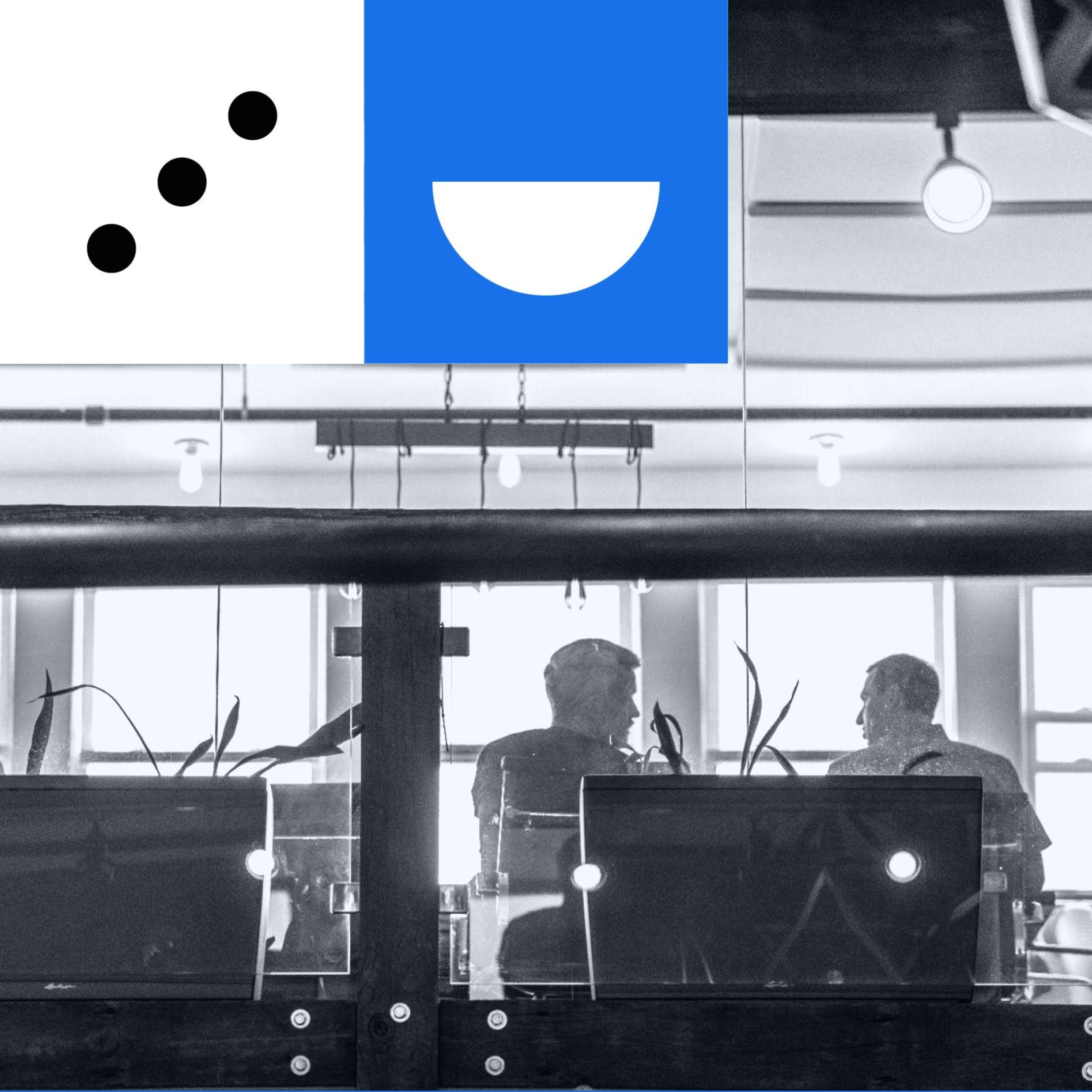 Two team members collaborating in the conference room.