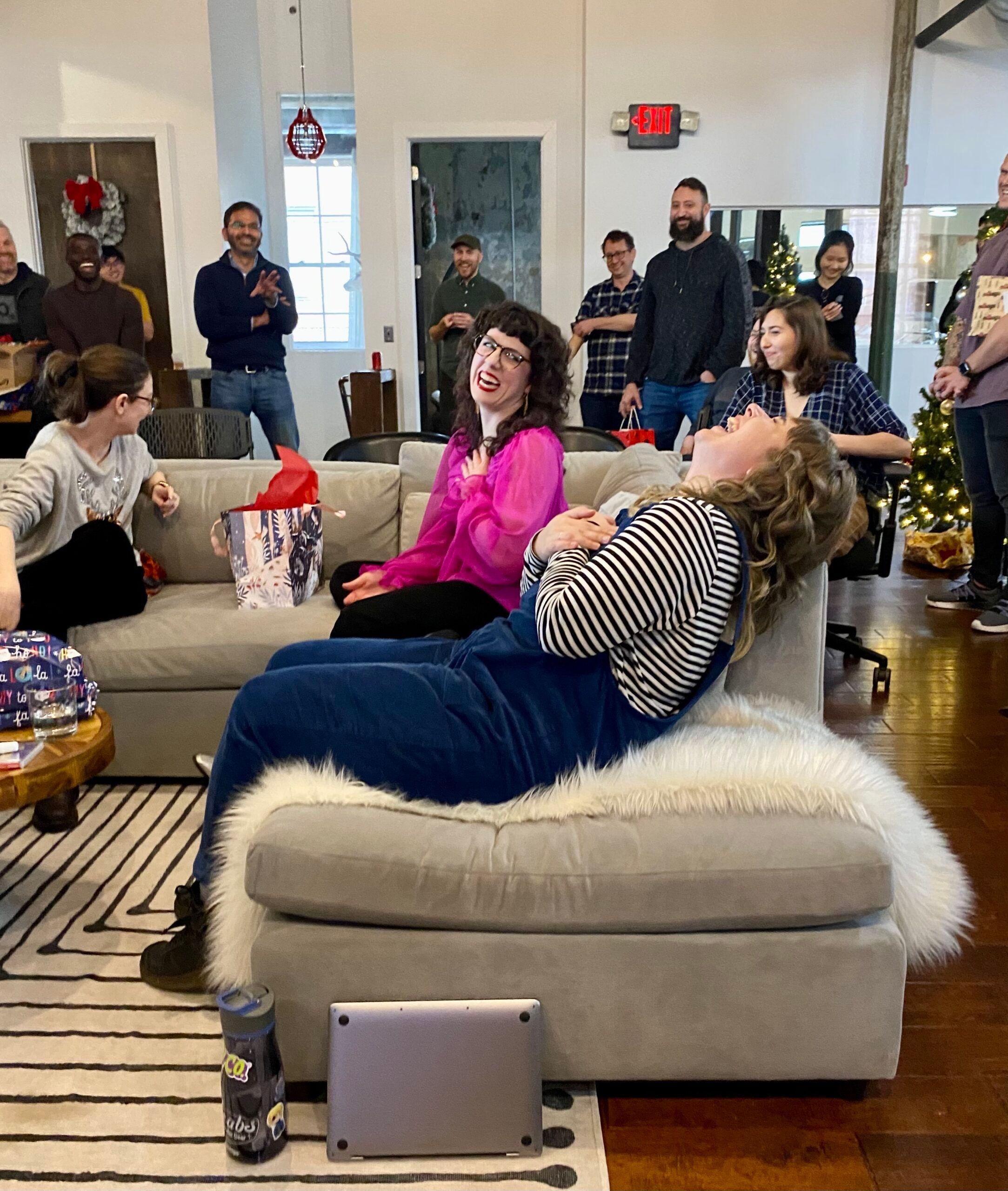 Two team members laughing during gift exchange.