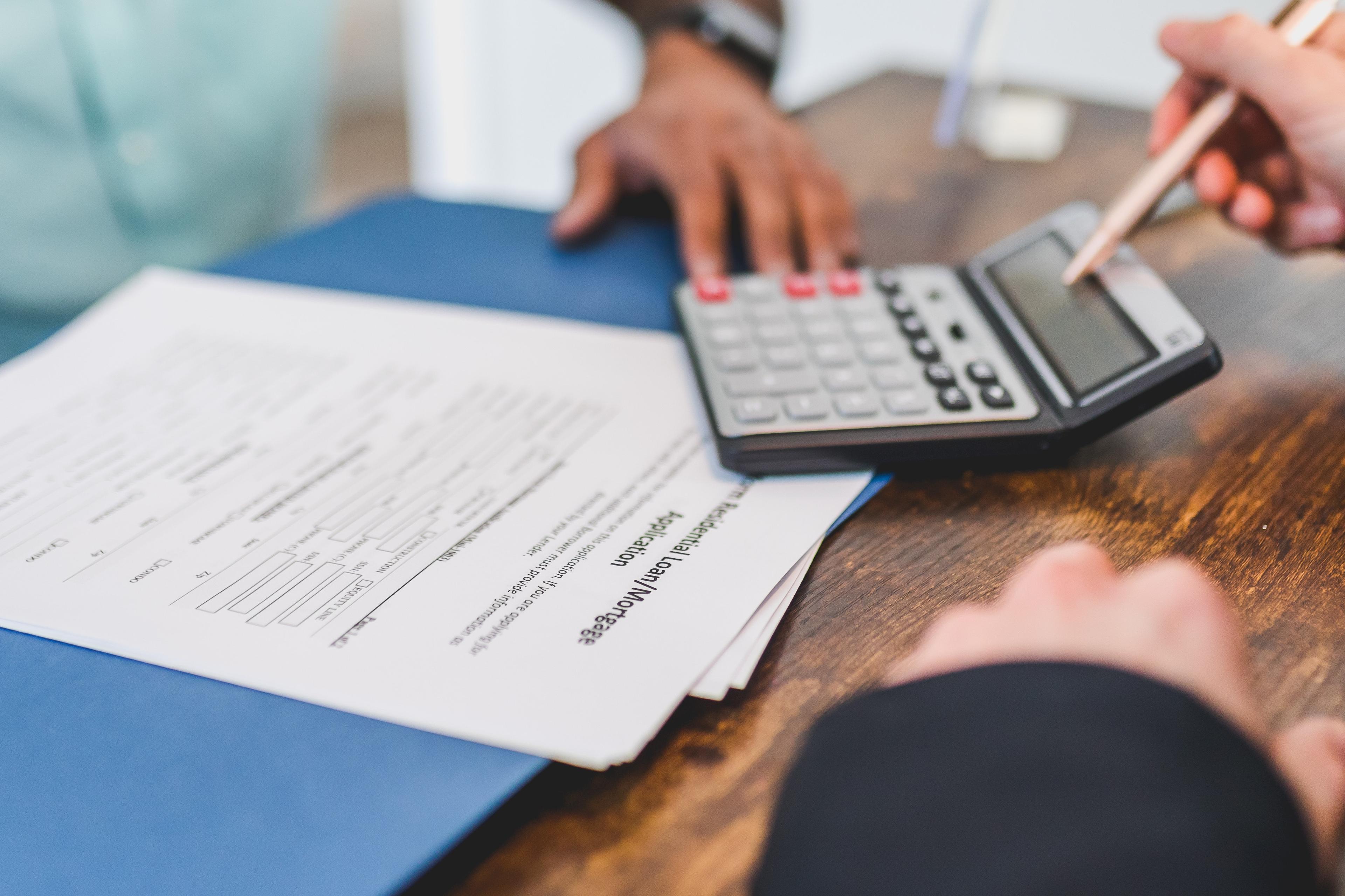 Free Real Estate Agent Calculating an Amount to a Client Stock Photo