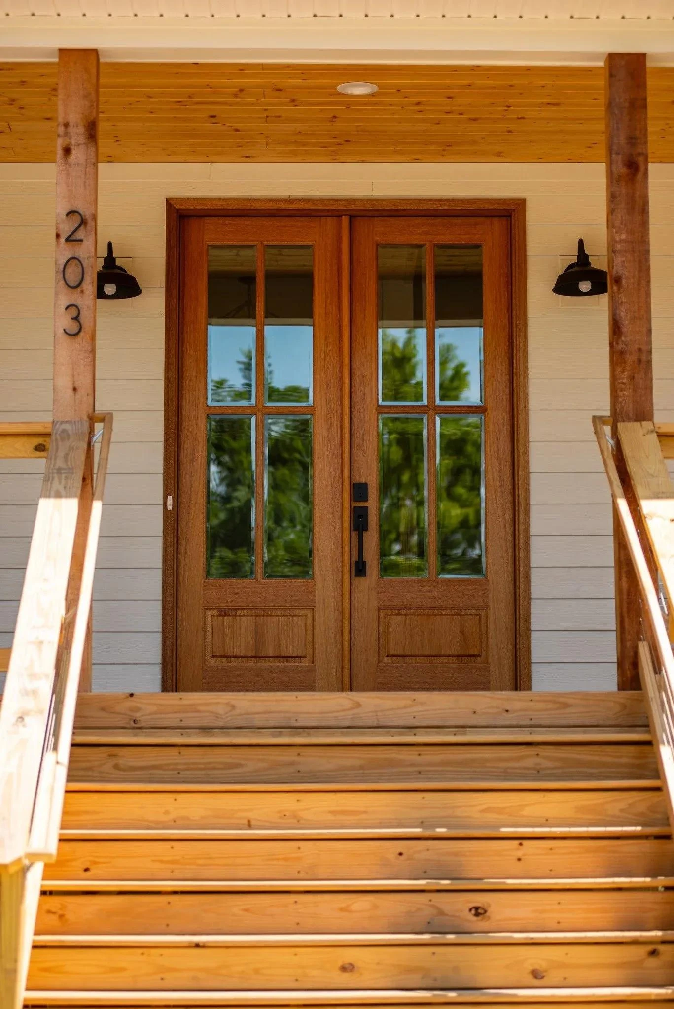 Front entrance of a custom home with wood double doors