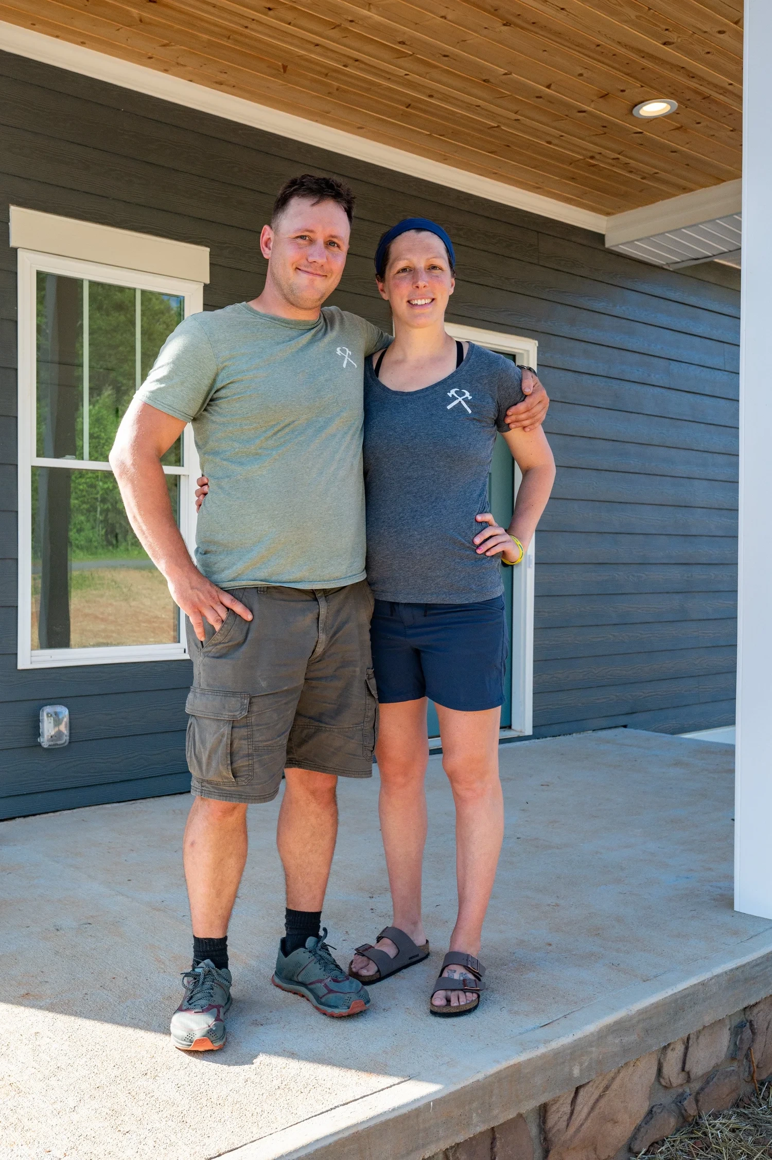Josh and Kara standing together outside a house