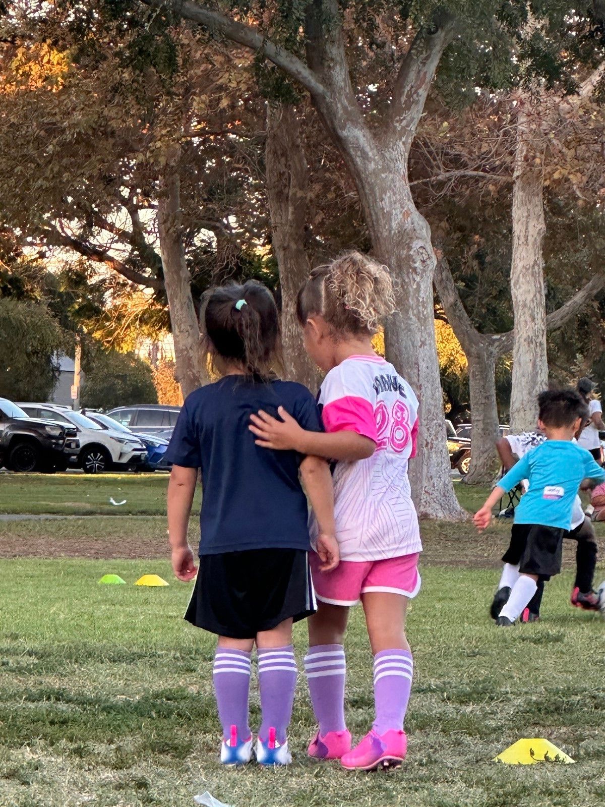 Young players smiling together at a Skills Night session.