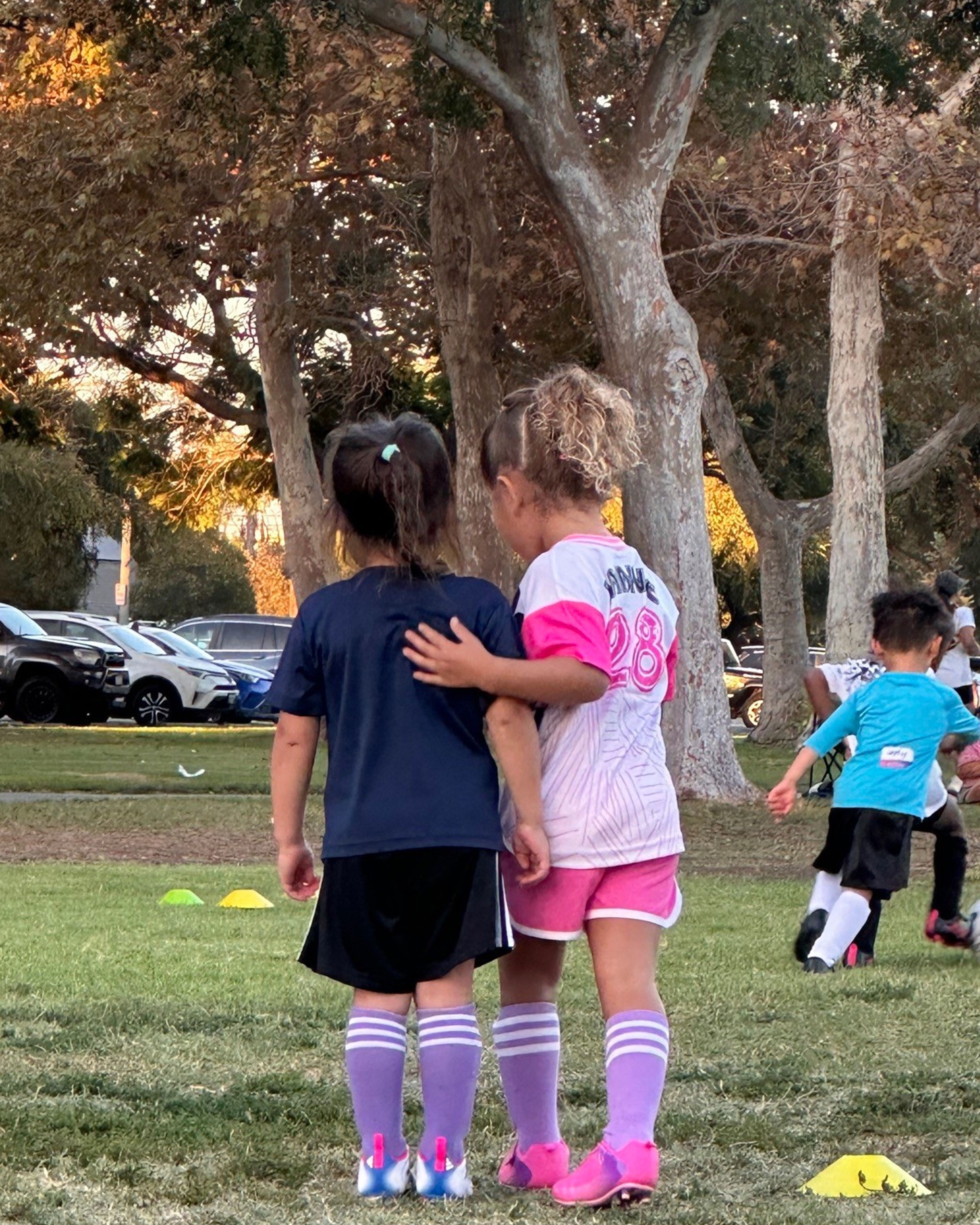 Young players smiling together at a Skills Night session.