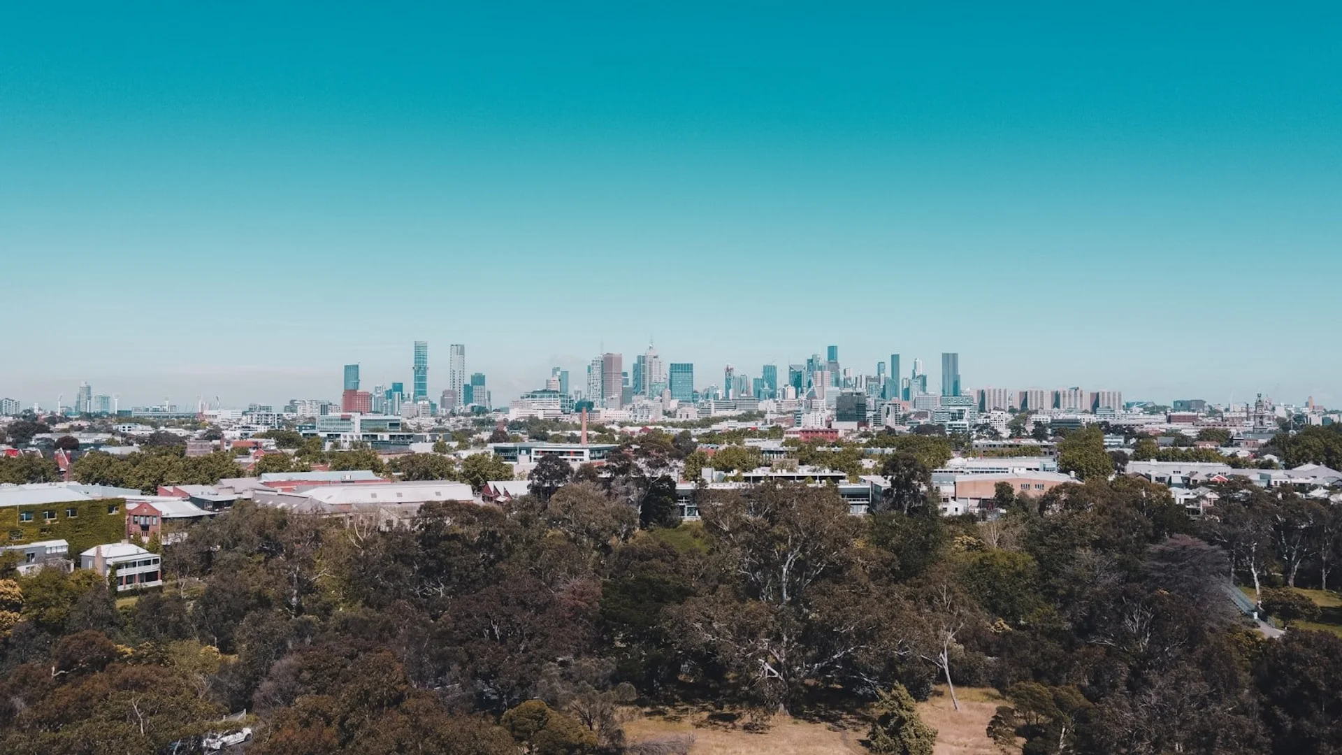 Aerial view of Melbourne skyline at sunset with Flinders Street Station and Federation Square in foreground