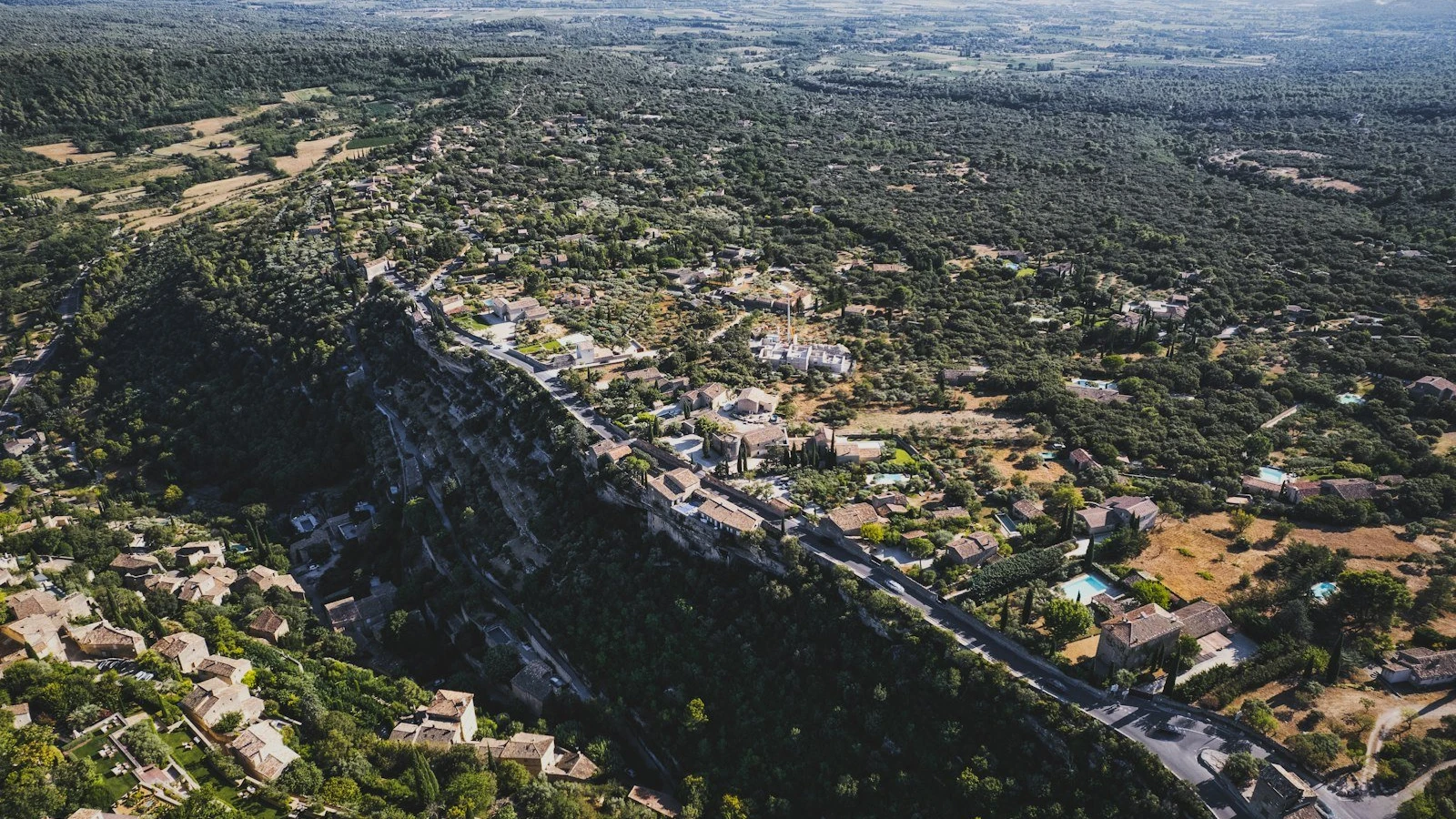 an aerial view of a city with a mountain in the background