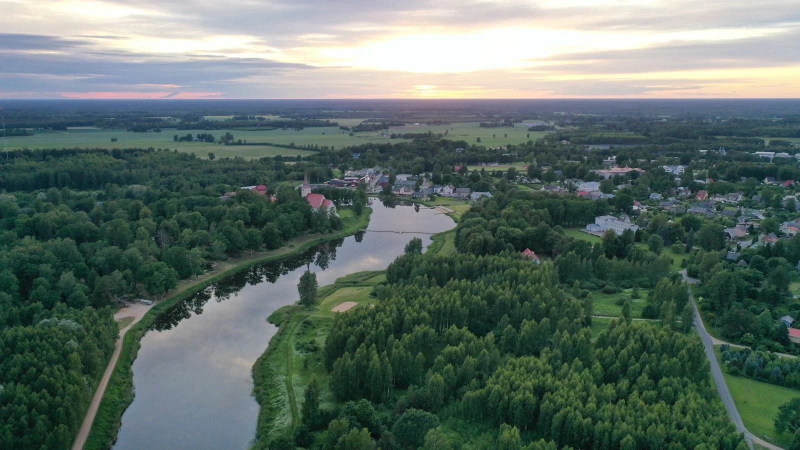 Aerial view over Suure-Jaani, Estonia, during sunset. Summer 2024.
