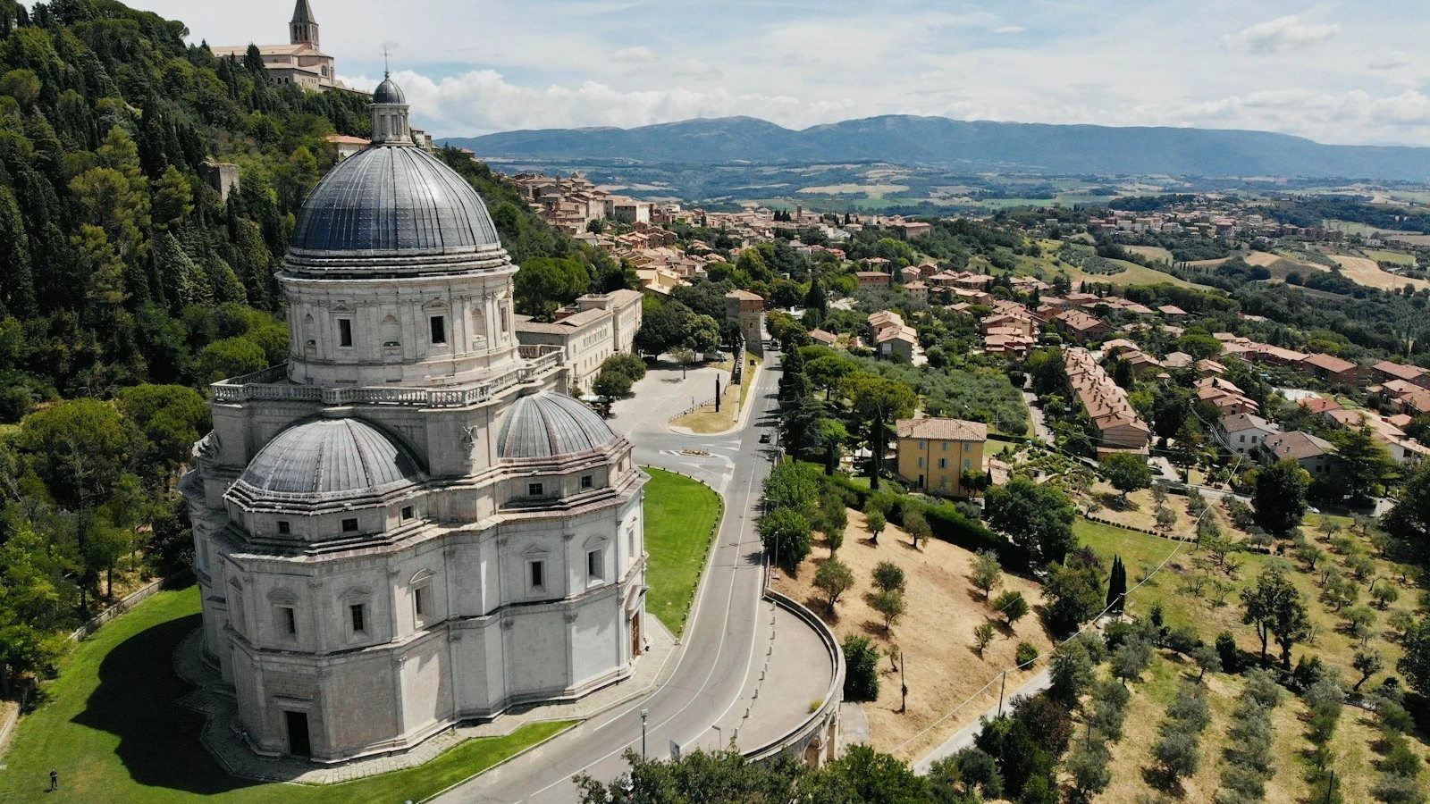 a large building with a dome on top surrounded by trees