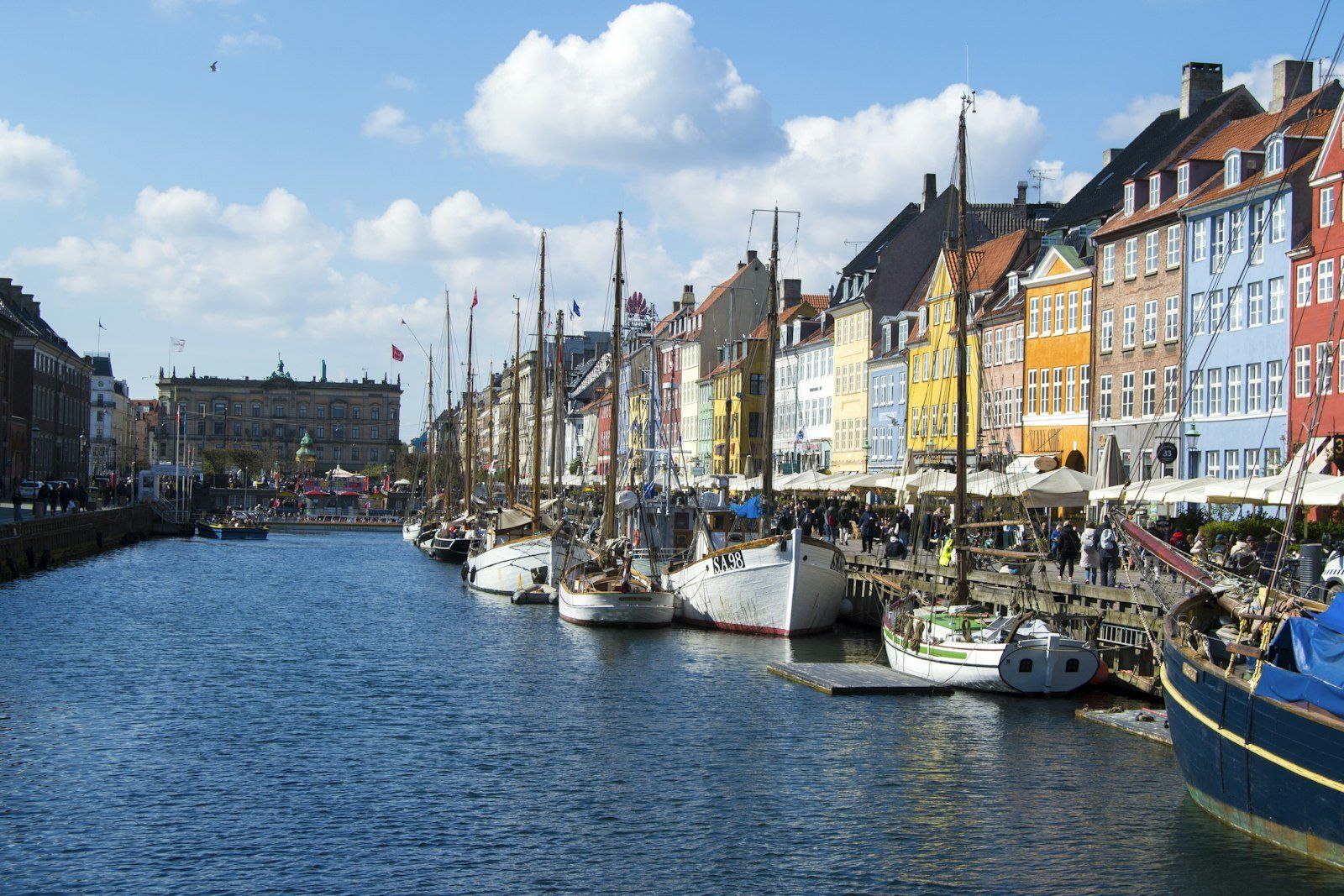 A row of boats sitting next to each other on a river