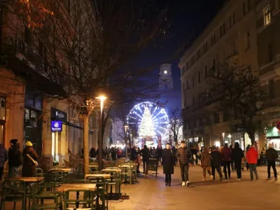 Vista panorámica de Cluj-Napoca con la Iglesia de San Miguel y la Piața Unirii al atardecer, rodeada de arquitectura histórica y moderna