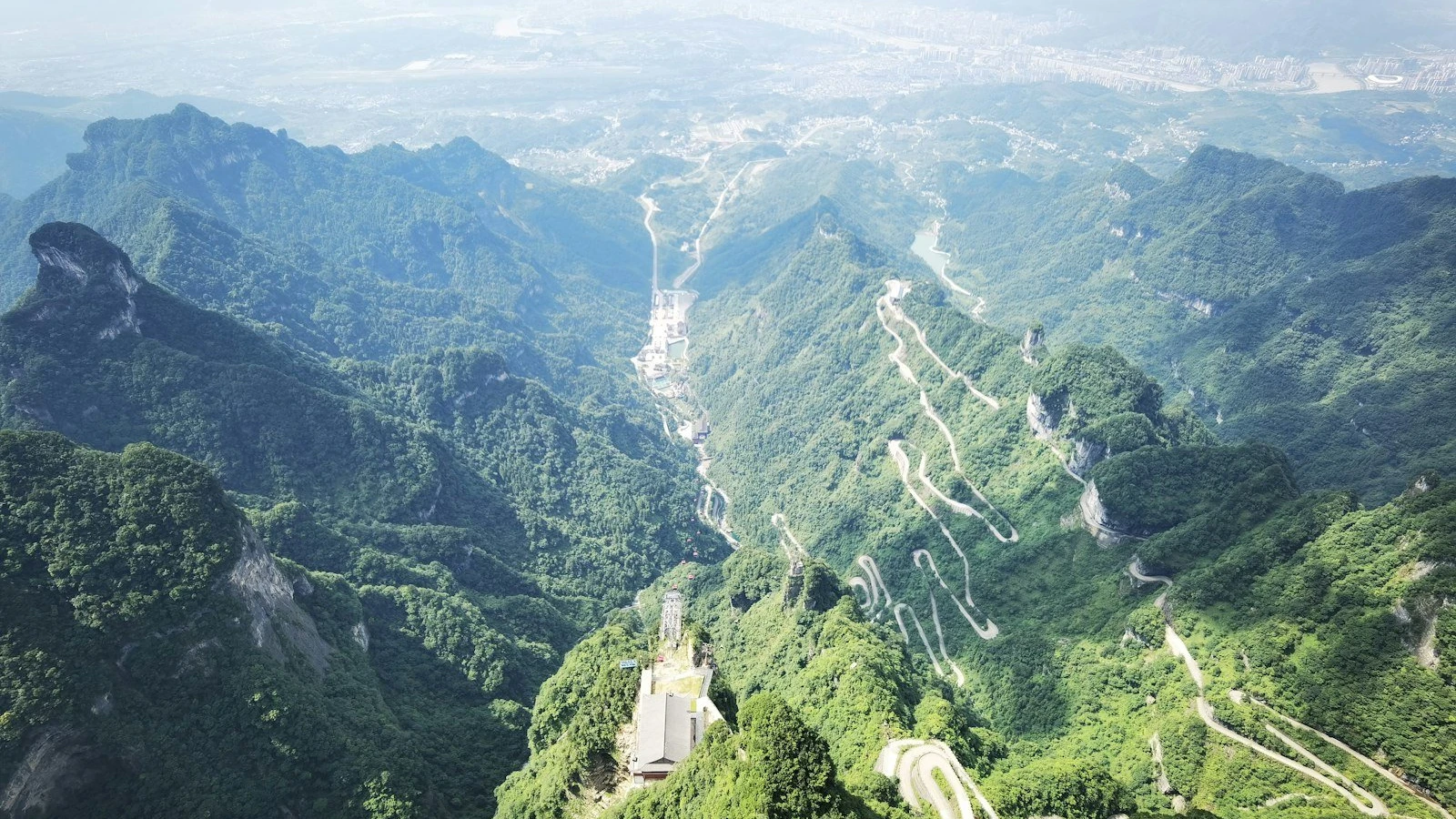 a scenic view of a mountain with a winding road