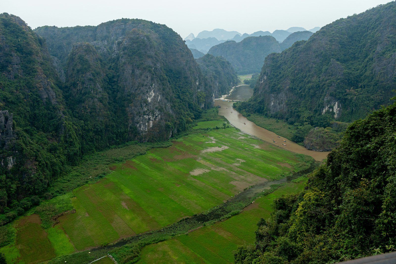 A valley surrounded by mountains with a river.