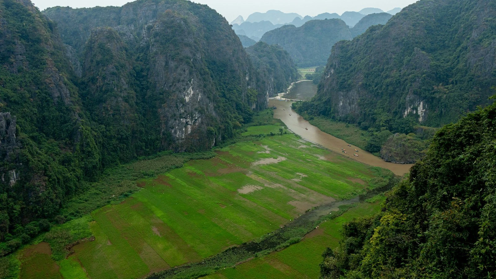 A valley surrounded by mountains with a river.