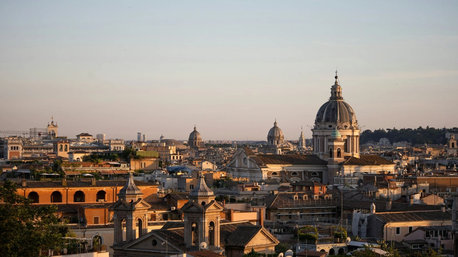 Vista panorámica del Coliseo romano al atardecer con el Arco de Constantino en primer plano