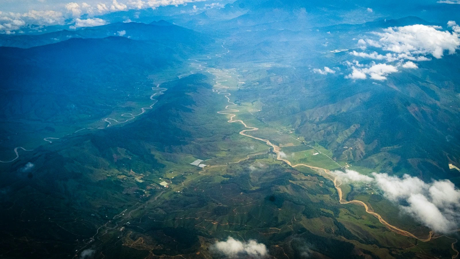an aerial view of a river running through a valley