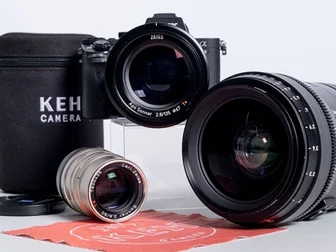 KEH Camera repair technicians servicing a Zeiss lens at the Atlanta facility