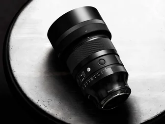 Sigma 85mm F1.2 DG Art lens official product photo on a dark background
