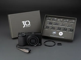 Ricoh GR IV 30th Anniversary Edition Kit — gunmetal compact body with diamond-cut lens ring cap, official Ricoh CDN product photo