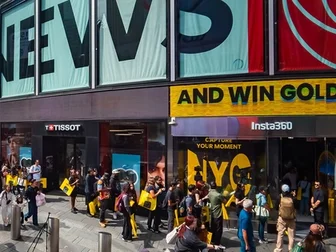 Crowd gathered on the sidewalk outside the new Insta360 flagship store in Times Square, with Tissot and other brand signage visible