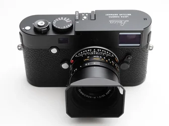 A 1970s Leica Summicron-M 35mm f/2 manual focus lens mounted on a Leica M-P body — the kind of vintage glass that inspired the manual-lens-on-mirrorless movement