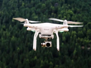 Drone flying over a dramatic mountain valley at golden hour