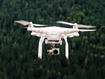Drone flying over a dramatic mountain valley at golden hour