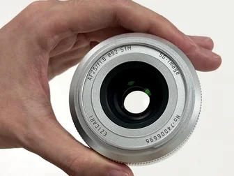 SG-Image AF 25mm f/1.8 lens for Micro Four Thirds cameras, shown in product photo against light background