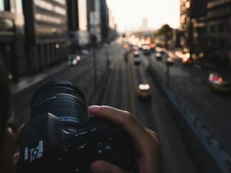 Street photography camera - person holding camera in urban environment