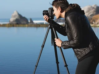 Photographer shooting with the Peak Design Travel Tripod in real-world outdoor conditions