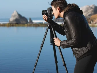 Photographer shooting with the Peak Design Travel Tripod in real-world outdoor conditions