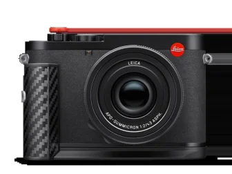 Leica Q3 43 Formula 1 Edition, official product photo from Leica Camera showing the motorsport-edition full-frame camera with carbon-fibre grip, black Microvelour body and engraved top plate