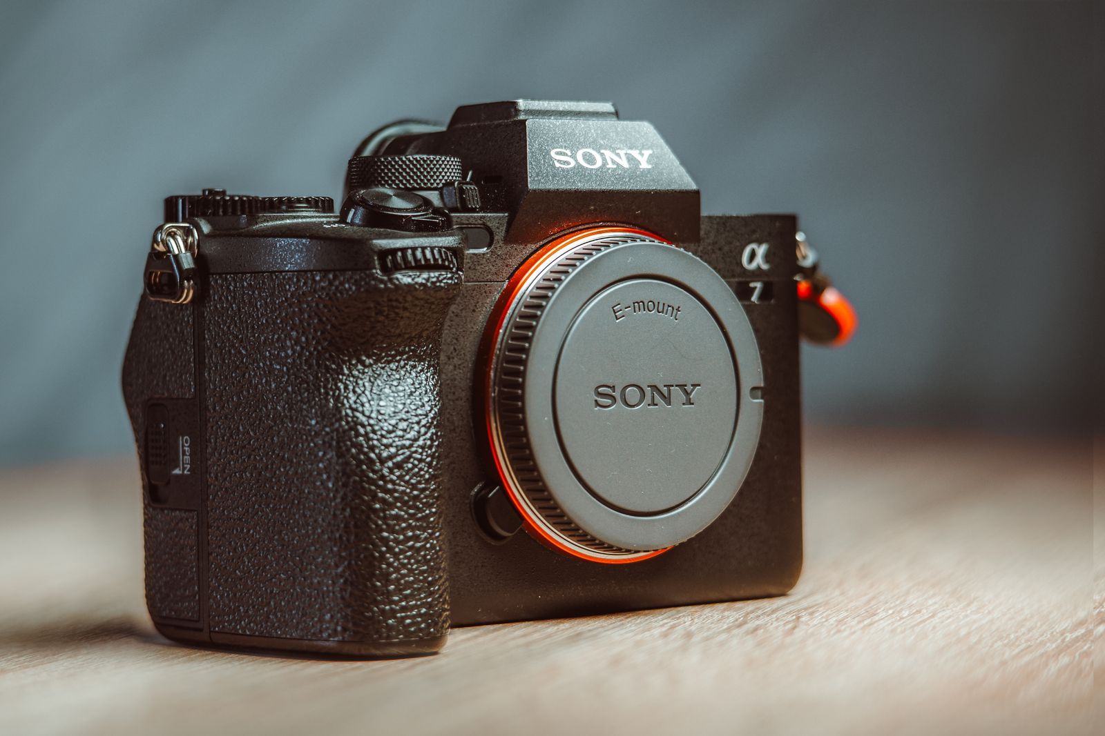 Sony Alpha mirrorless camera with E-mount lens on black fabric background