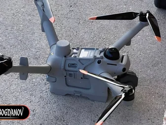 DJI Matrice 5TD prototype drone with arms folded on asphalt, showing top deck antenna and multi-window gimbal, photographed by Igor Bogdanov on September 26, 2026