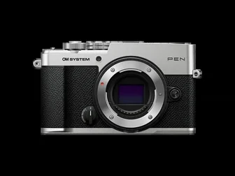 OM System PEN mirrorless camera body, silver, front three-quarter view, showing retro-styled top dial layout